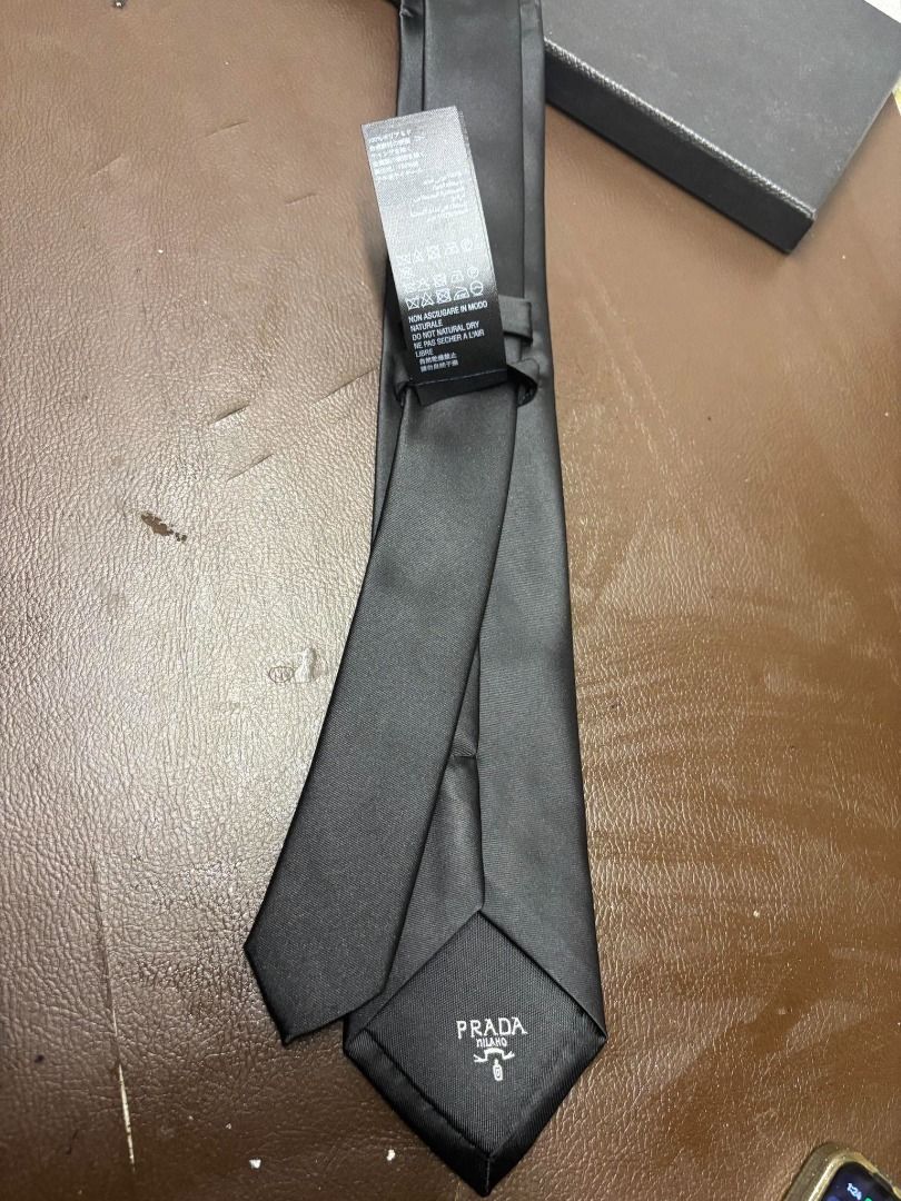 Prada Re-Nylon Gabardine Tie | Black | Complete Set (Category: Ties) located in Bacoor. Submitted by fafofa (Listing ID 1465104162, Image 3). Description: Prada Re-Nylon Gabardine Tie in black, featuring the iconic enameled metal Prada triangle logo. • Prada Re-Nylon Gabardine • Black • Enameled metal triangle logo • Complete set • Includes original box • Includes tags.
