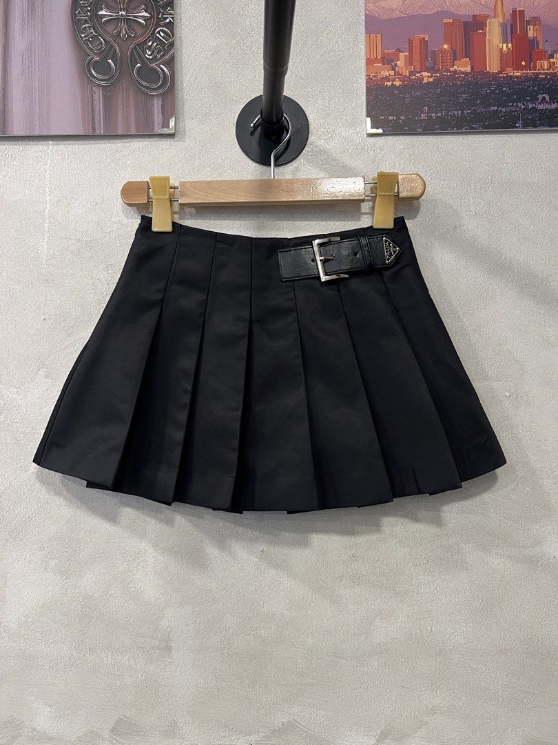 Prada Re-Nylon Pleated Mini skirt (Category: Skirts) located in Quezon City. Submitted by shanks. (Listing ID 1465043974, Image 2). Description: Prada Pleated Re-Nylon Miniskirt, which stands out with its signature enameled metal triangle logo on the leather waist strap. Size : 36 on tag Dimensions : Length : 12.5 inches Waistline : 25 inches Sign of wear in good condition .