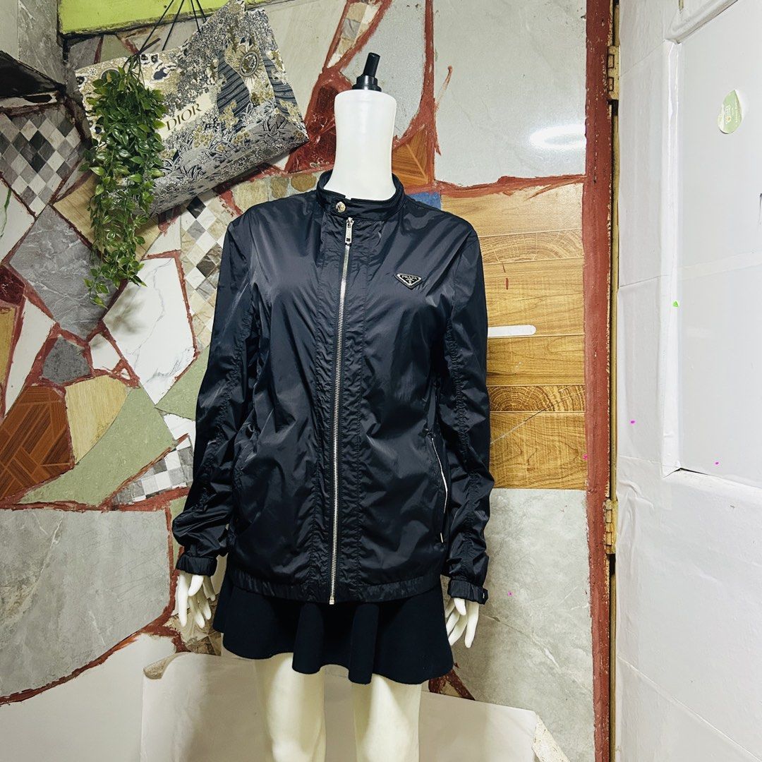 Prada windbreaker lightweight jacket (Category: Luxury Apparel) located in Baguio. Submitted by kckc_luxury (Listing ID 1465108094, Image 2). Description: 🌸 TINY PINK SPOTS ARE LENS DAMAGE, NOT CLOTH STAINS ————————— ❗️KINDLY READ BEFORE MAKING AN OFFER❗️ LISTING DETAILS size:M width x length (inches):21x28 condition: EXCELLENT --- MOP: Gcash / BPI MOD: J&T / JRS LOCATION: Baguio City --- NOTE: • Manage your expectations • Photos did not go unde
