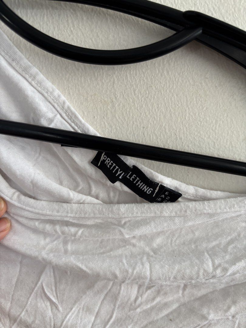 PrettyLittleThing White One-Shoulder Crop Top (Category: Sleeveless) located in Muntinlupa City. Submitted by jc444_ (Listing ID 1465111880, Image 2). Description: - Brand: PrettyLittleThing - Style: One-shoulder crop top - Color: White - Size: UK 6 - Material: Stretchy and comfortable fabric - Condition: Worn a couple of times, plenty of wear left - Perfect for pairing with high-waisted jeans, skirts, or cargo pants.