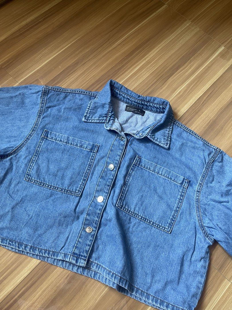 Primark Denim Cropped Polo (Category: Shirts) located in Antipolo. Submitted by wh0smarga (Listing ID 1464989088, Image 1). Description: - Brand/Line: Primark Cares - Size: Large to Semi XL - Color: Blue wash - Style: Cropped fit denim polo - Details: Button-up front with silver-tone metal buttons, classic collar neck, two chest pockets - Fabric: Soft denim, great for layering or wearing solo.