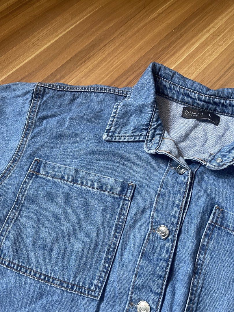 Primark Denim Cropped Polo (Category: Shirts) located in Antipolo. Submitted by wh0smarga (Listing ID 1464989088, Image 3). Description: - Brand/Line: Primark Cares - Size: Large to Semi XL - Color: Blue wash - Style: Cropped fit denim polo - Details: Button-up front with silver-tone metal buttons, classic collar neck, two chest pockets - Fabric: Soft denim, great for layering or wearing solo.
