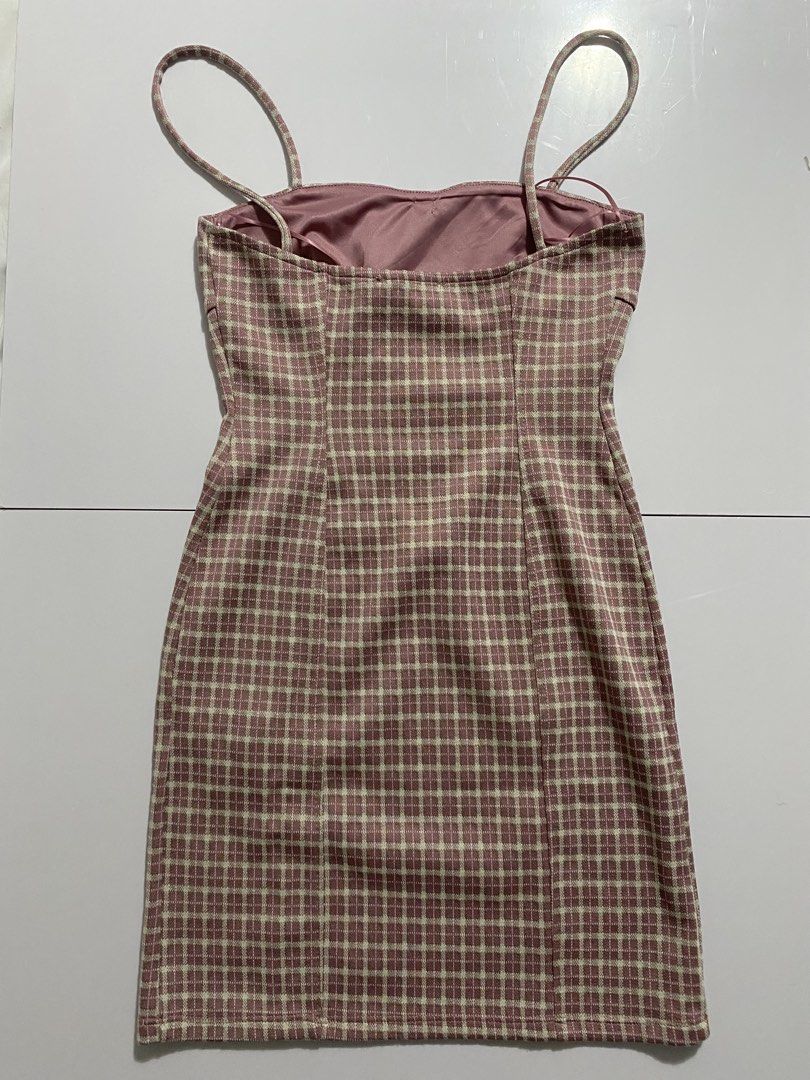 Pull&Bear Pink Plaid Mini Dress Size S NWT (Category: Dresses) located in Vigan. Submitted by wrenessie (Listing ID 1465155827, Image 2). Description: - Brand: Pull&Bear - Condition: Brand new with original store tags - Size: EUR S / USA S / MEX 26 - Design: Pink and white plaid pattern, bodycon fit, straight hem - Details: Thin spaghetti straps, sweetheart neckline, and center front fabric rosebud accent - Lining: Fully lined inside.
