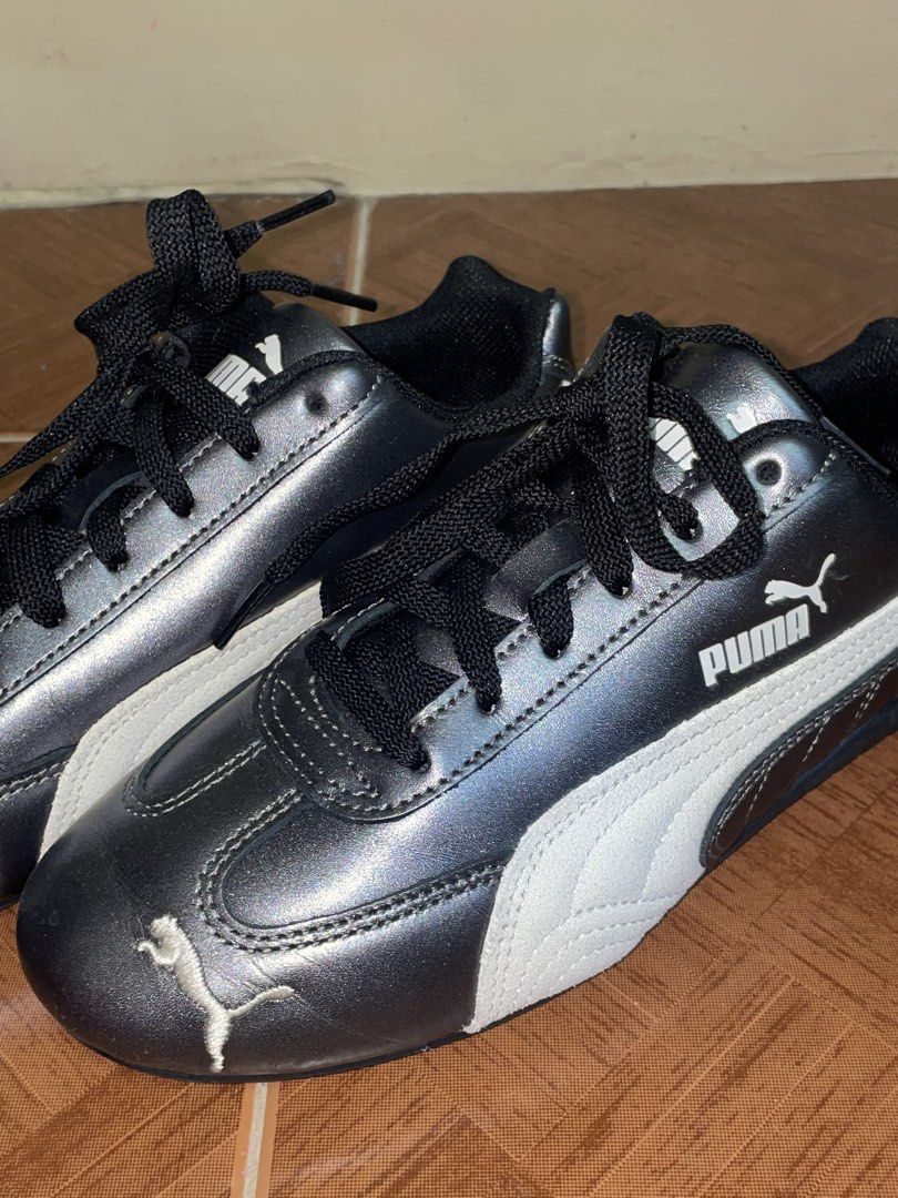 Puma Metallic Grey and White Sneakers (Category: Sneakers) located in Manila. Submitted by ninchyyy (Listing ID 1465072042, Image 3). Description: - Brand/Model: Puma Sneakers - Color: Metallic grey with white suede formstrips and black accents - Design: Low-top casual style with textured outsoles - Details: Signature white Puma jumping cat logo on toe cap, tongue, and side - Condition: Good condition.