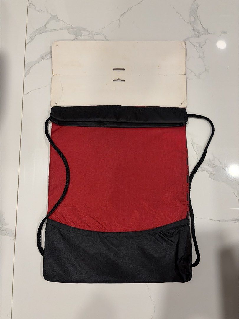 Puma Red and Black Gym Sack Drawstring Bag (Category: Backpacks) located in Manila. Submitted by miguelfits (Listing ID 1465071595, Image 2). Description: - Brand: Puma - Condition: Brand new with original header packaging - Design: Red and black with allover logo pattern and large white leaping cat logo - Features: Heavy-duty black bottom panel and thick black drawstring cords - Ideal for: Gym workouts, sports, or casual everyday carry.