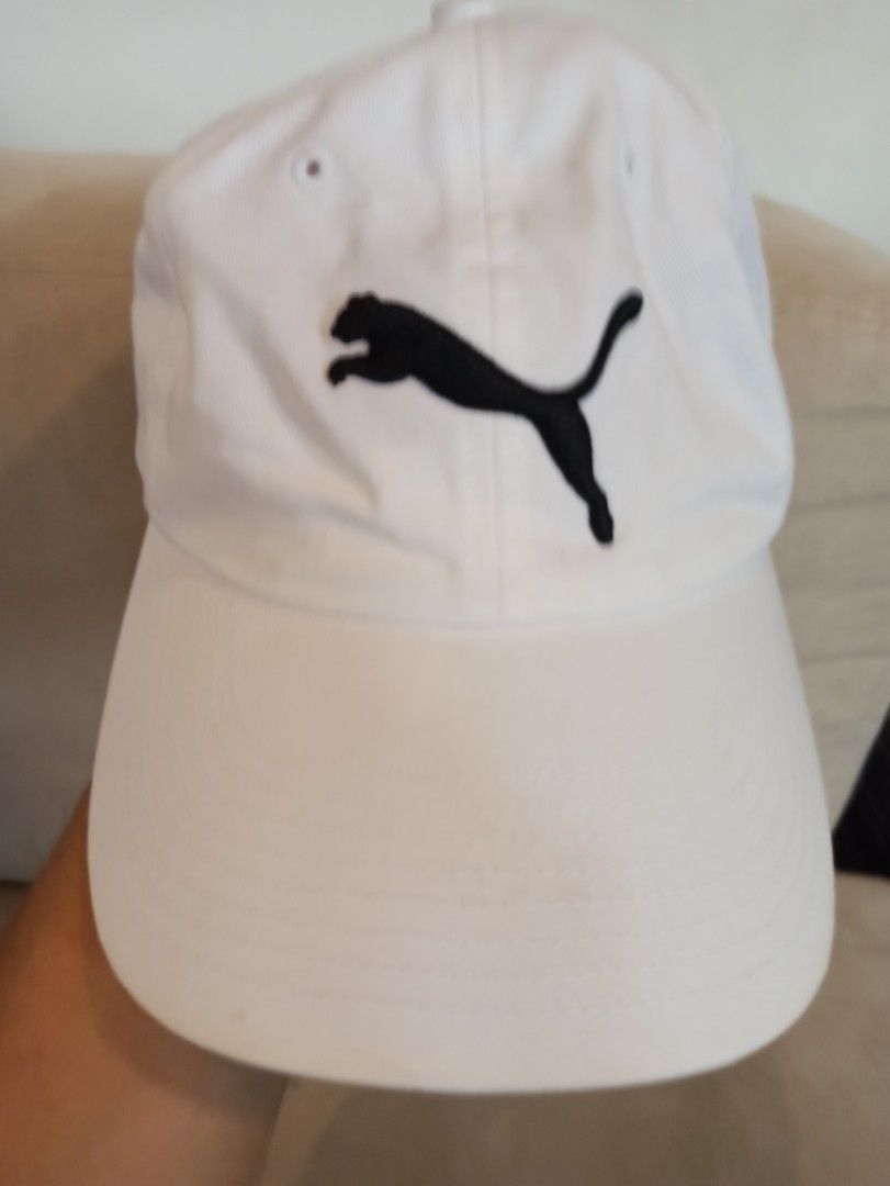 Puma White Cap with Black Logo (Category: Caps & Hats) located in Caloocan City. Submitted by rtarellano (Listing ID 1464994805, Image 1). Description: - Brand: Puma - Color: White with black embroidered leaping cat logo - Style: Classic curved brim baseball cap - Fit: Adjustable strap at the back for a custom fit - Condition: Like new with interior tags attached, completely clean inside and out - Ideal for: Casual everyday wear and sporty outfit
