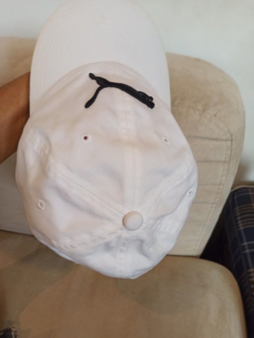 Puma White Cap with Black Logo (Category: Caps & Hats) located in Caloocan City. Submitted by rtarellano (Listing ID 1464994805, Image 2). Description: - Brand: Puma - Color: White with black embroidered leaping cat logo - Style: Classic curved brim baseball cap - Fit: Adjustable strap at the back for a custom fit - Condition: Like new with interior tags attached, completely clean inside and out - Ideal for: Casual everyday wear and sporty outfit