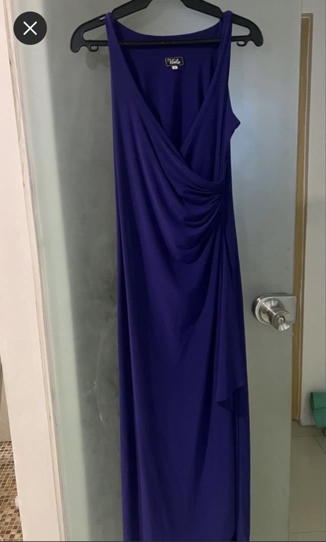 Purple Long Formal Gown - Plus size XL (Category: Dresses) located in Mandaluyong City. Submitted by zimimi12 (Listing ID 1464991516, Image 2). Description: - Brand: Viola - Color: Purple - Size: XL to XXL - Design: V-neckline, sleeveless, with a stylish draped front overlay - Length: Full length, flattering fit - Condition: Worn only once, clean, and ready to wear - Material: Stretchy, comfortable fabric.