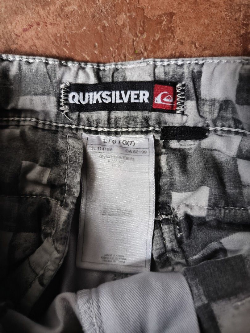 Quiksilver Boy's Shorts Size 7 (Category: Babies & Kids Fashion) located in Gumaca. Submitted by makuliti (Listing ID 1464978035, Image 2). Description: - Brand: Quiksilver - Item: Boy's casual shorts - Color: Light grey - Size: L/G/7 - Details: Button closure, front pockets, belt loops, and embroidered logo patch on lower left leg - Condition: Authentic with inner brand and RN tags.