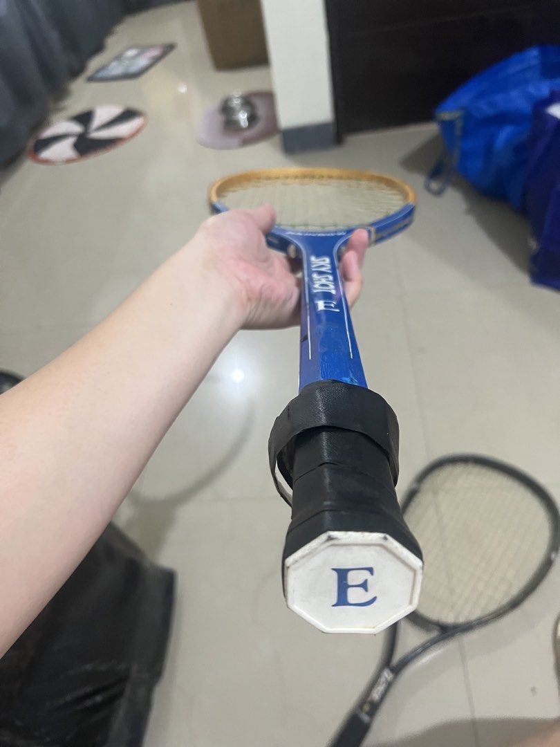 Rainbow Sky Shot E TS-900 Tennis Racket (Category: Racket and Ball Sports) located in Manila. Submitted by ajdfinds (Listing ID 1465003422, Image 2). Description: - Model: Rainbow Sky Shot E TS-900 (Made in Taiwan) - Design: Blue frame with a stylish wooden top accent and white strings - Grip: Black grip tape with an 'E' logo on the bottom cap - Condition: Normal wear on the paint and frame from previous play - Great for casual play or collectors