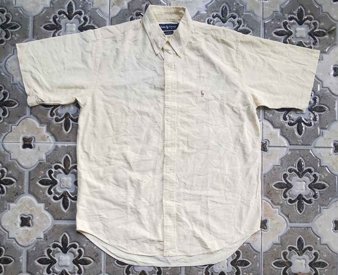 Ralph Lauren Blake Short Sleeve Button Down Shirt Yellow M (Category: Tshirts & Polo Shirts ) located in Davao. Submitted by dmp1993 (Listing ID 1465048721, Image 1). Description: Ralph Lauren Blake short sleeve button-down shirt. Classic yellow colorway in 100% cotton material. Features a button-up front collar and embroidered pony logo on the left chest. Tagged size medium. Made in Hong Kong. Standard fit for casual everyday wear..