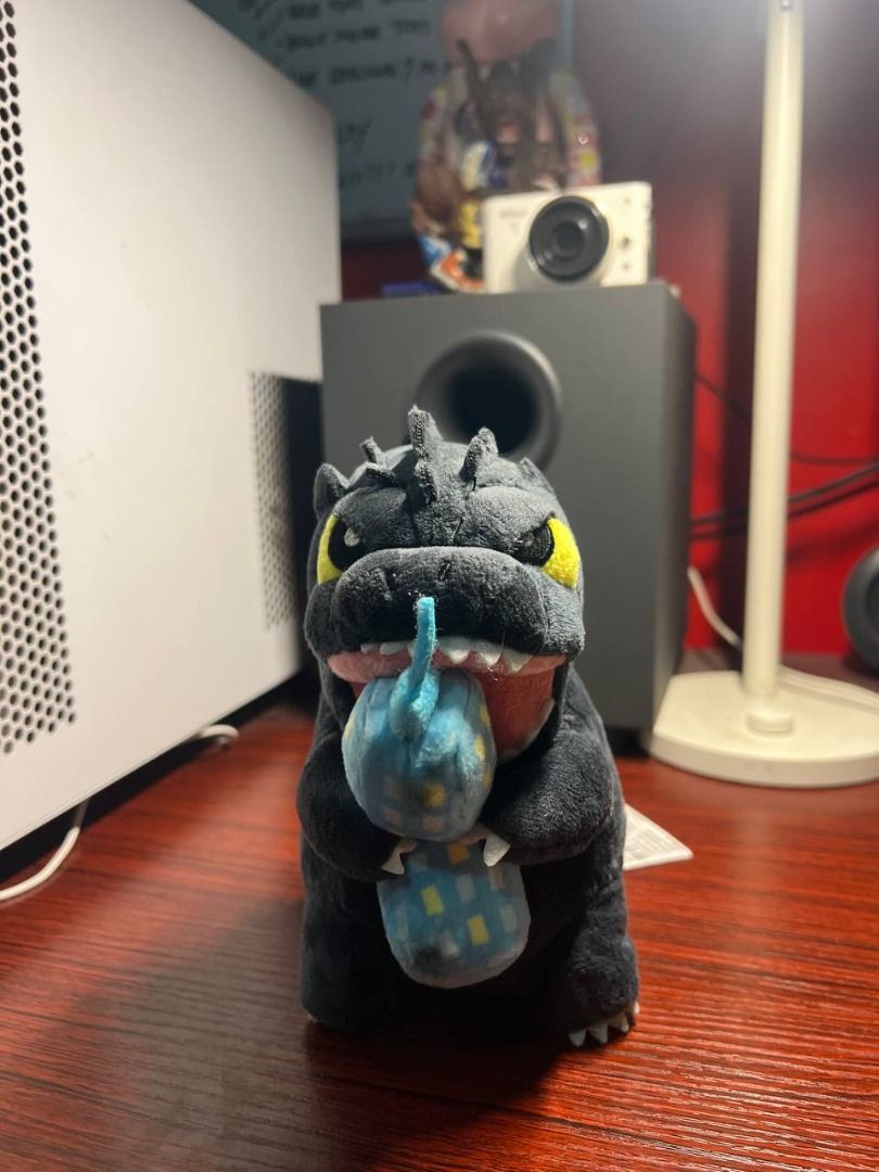RAre Godzilla Plush Toy (Category: Plushies & Soft Toys) located in Baguio. Submitted by ditoyzb08176 (Listing ID 1465105829, Image 3). Description: - Adorable Godzilla plush toy featuring soft dark grey fabric and classic white dorsal spikes - Detailed with striking yellow eyes and Godzilla biting into a blue building - Includes the original red Godzilla tag attached to the tail - Great addition for collectors or as a gift for monster movie fans