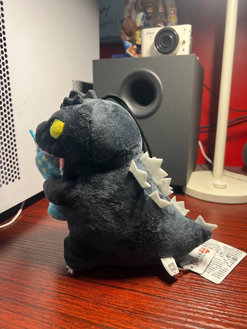 RAre Godzilla Plush Toy (Category: Plushies & Soft Toys) located in Baguio. Submitted by ditoyzb08176 (Listing ID 1465105829, Image 2). Description: - Adorable Godzilla plush toy featuring soft dark grey fabric and classic white dorsal spikes - Detailed with striking yellow eyes and Godzilla biting into a blue building - Includes the original red Godzilla tag attached to the tail - Great addition for collectors or as a gift for monster movie fans