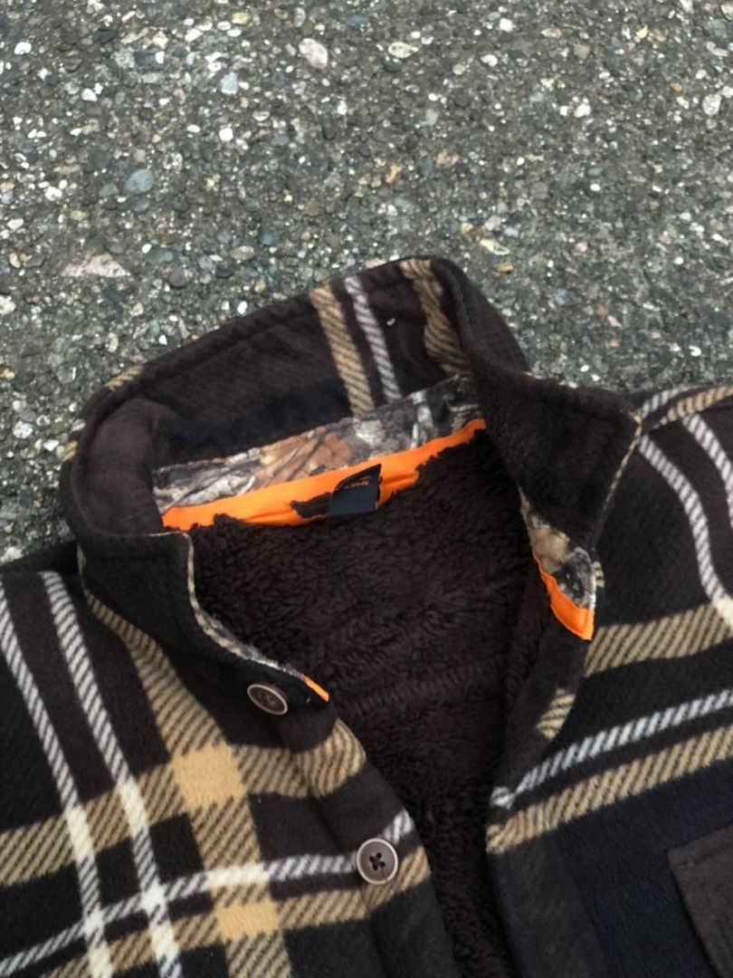 Realtree Fleece Plaid Button-Up Jacket (Category: Coats, Jackets and Outerwear) located in Tacloban City. Submitted by thedropout (Listing ID 1465053110, Image 2). Description: - Brown and black plaid fleece jacket with rugged outdoor style - Warm Sherpa fleece lining for extra cold protection - Realtree camo accents on the inner collar and cuffs - Dual chest pockets with secure button flaps - Classic front button closure - Great layering piece f