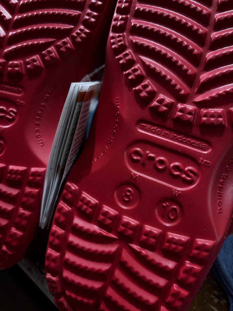 Red Crocs Classic Clogs Size M8 W10 (Category: Slippers & Slides) located in Mandaluyong City. Submitted by aceandres (Listing ID 1464989892, Image 3). Description: - Item: Crocs Classic Clogs - Color: Bright Red - Size: Men's 8 / Women's 10 - Condition: Brand new with original tags attached - Origin: Made in Indonesia - Features: Slip-on design, breathable ventilation holes, and secure heel strap.