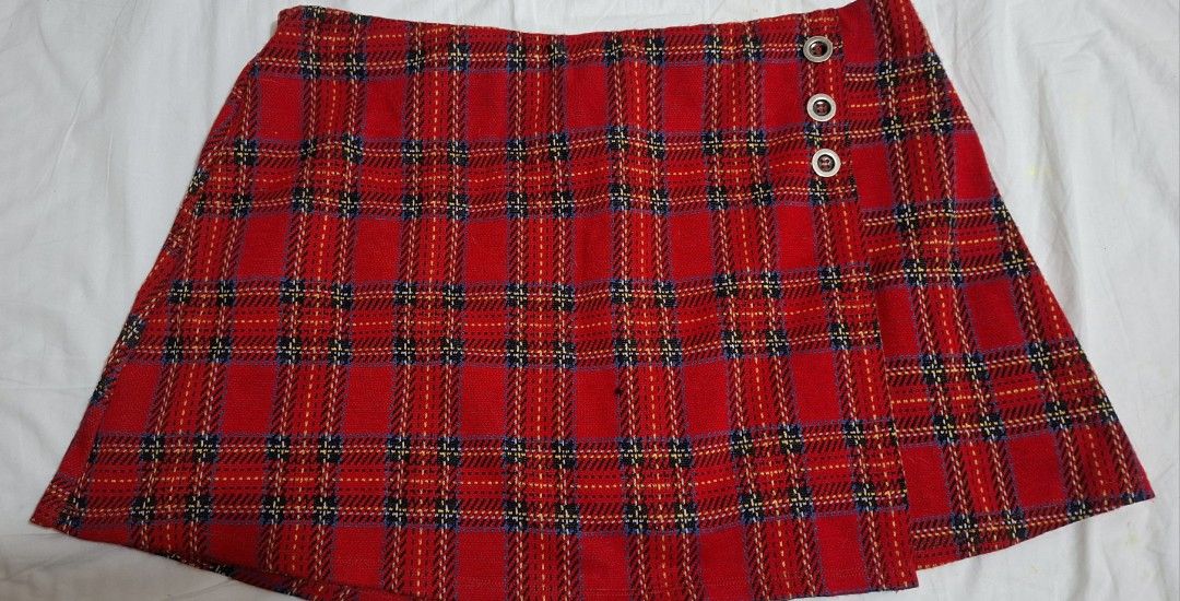 Red Plaid Skort skirt (Category: Skirts) located in Taguig. Submitted by wolffangs (Listing ID 1465012907, Image 2). Description: Red tartan plaid garterized skort with built-in shorts - Material: Thick, textured woven fabric - Waist measures approx. 15.5 inches across (laid flat) see picture with measuring tool.