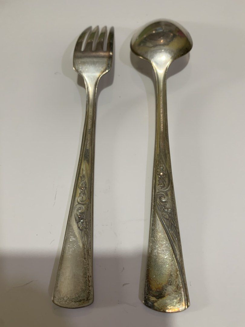 Revelation Silver Plate Fork and Spoon Set (Category: Dinnerware & Cutlery) located in Antipolo. Submitted by cebb888 (Listing ID 1464972283, Image 1). Description: - Vintage 2-piece cutlery set including a fork and spoon - Stamped 'Revelation Silver Plate' on the handles - Features detailed floral and scroll engravings on the lower handles - Shows noticeable tarnish, patina, and discoloration due to age and use - Solid metal silverware ideal for