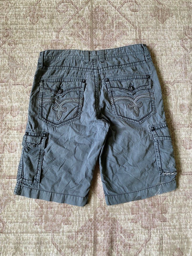 Rock Revival Grey Cargo Shorts Size 36 (Category: Shorts) located in Manila. Submitted by diporosmoh43681 (Listing ID 1465000390, Image 1). Description: - Brand: Rock Revival - Style: Cargo shorts in grey corduroy-textured fabric - Size: 36 (indicated on waistband label) - Pockets: Multiple utility pockets including buttoned cargo side pockets and flapped rear pockets - Details: Signature rear pocket embroidery, stylish topstitching throughout, a
