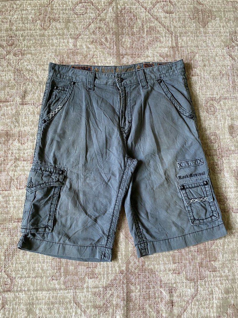 Rock Revival Grey Cargo Shorts Size 36 (Category: Shorts) located in Manila. Submitted by diporosmoh43681 (Listing ID 1465000390, Image 2). Description: - Brand: Rock Revival - Style: Cargo shorts in grey corduroy-textured fabric - Size: 36 (indicated on waistband label) - Pockets: Multiple utility pockets including buttoned cargo side pockets and flapped rear pockets - Details: Signature rear pocket embroidery, stylish topstitching throughout, a