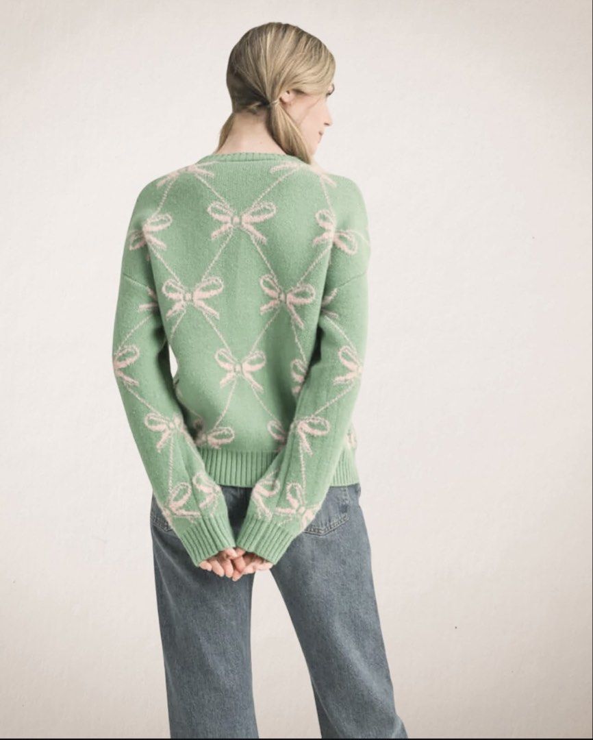 Sage Green and Pink Bow Pattern Knit Sweater (Category: Coats, Jackets and Outerwear) located in Manila. Submitted by cocoomelooonnnn (Listing ID 1465078252, Image 1). Description: - Color & Pattern: Sage green with a repeating pink bow diamond grid - Material: Soft, fuzzy texture for maximum warmth and comfort - Details: Ribbed crew neckline, cuffs, and hem - Condition: Brand new with tag still attached - Styling: Easy pullover style that pairs 