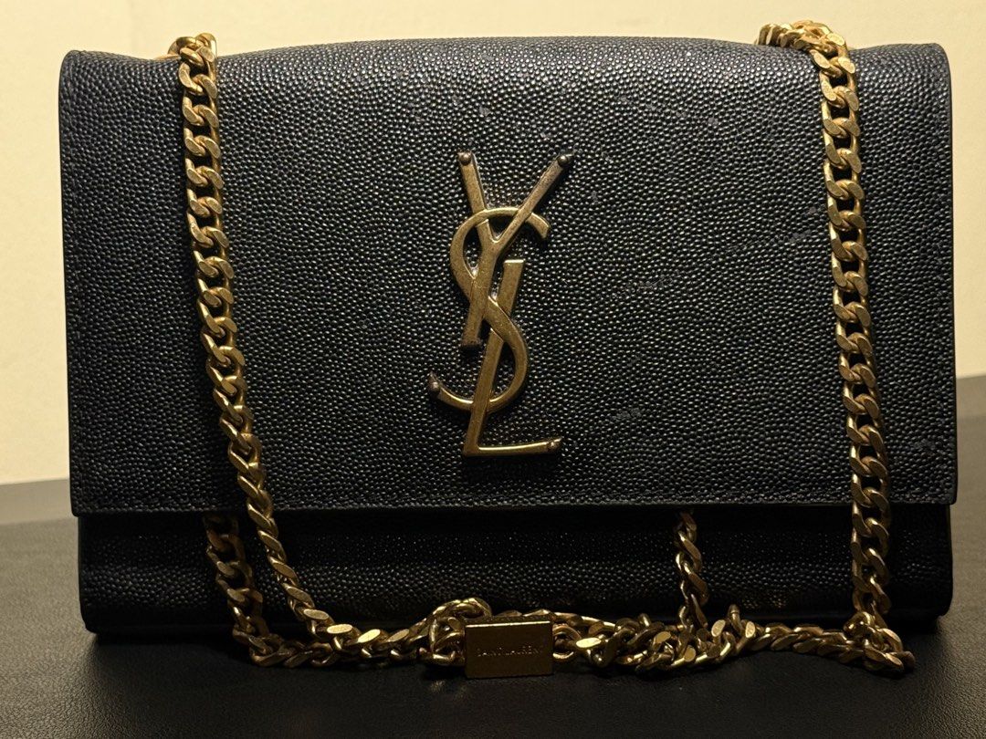 Saint Laurent YSL Monogram Black Grained Leather Chain Bag (Category: Luxury Bags & Wallets) located in Manila. Submitted by zuji.ph (Listing ID 1464994877, Image 1). Description: -Saint Laurent bag in classic black grained leather - Features signature gold-tone YSL logo hardware and matching chain strap with branded plaque - Structured silhouette with a secure foldover closure - Clean interior compartment with visible serial number stamping - Ve