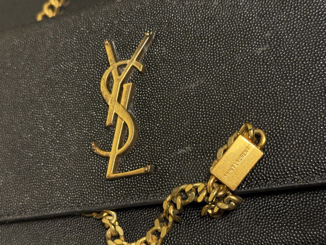 Saint Laurent YSL Monogram Black Grained Leather Chain Bag (Category: Luxury Bags & Wallets) located in Manila. Submitted by zuji.ph (Listing ID 1464994877, Image 3). Description: -Saint Laurent bag in classic black grained leather - Features signature gold-tone YSL logo hardware and matching chain strap with branded plaque - Structured silhouette with a secure foldover closure - Clean interior compartment with visible serial number stamping - Ve