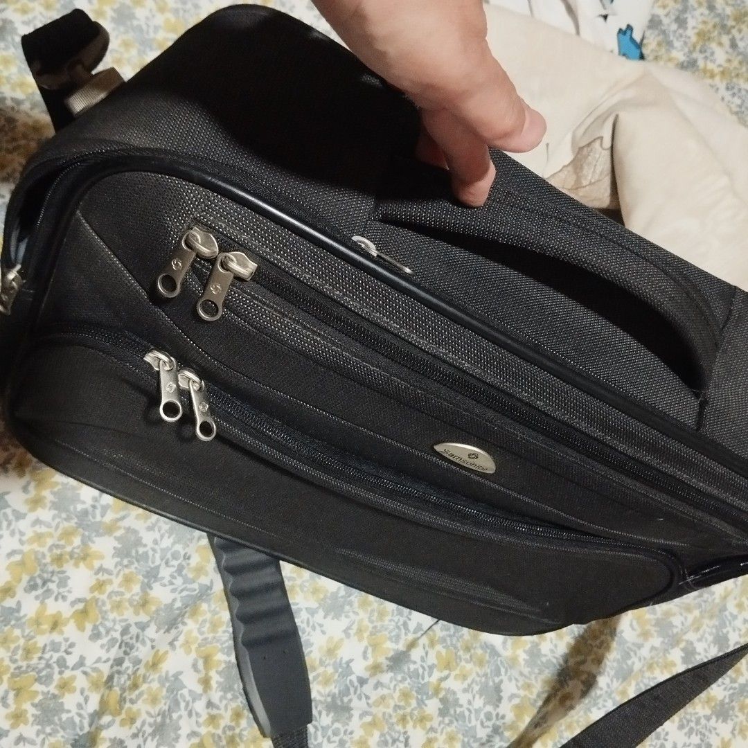 Samsonite Black Business Briefcase Bag with Shoulder Strap (Category: Briefcases) located in Manila. Submitted by lene48 (Listing ID 1465049937, Image 2). Description: - Brand: Samsonite - Color: Classic Black - Material: Sturdy, durable fabric with premium metal hardware - Compartments: Multiple zippered compartments and front pockets for maximum organization - Carry Options: Top carry handle and adjustable padded shoulder strap - Condition: Wel