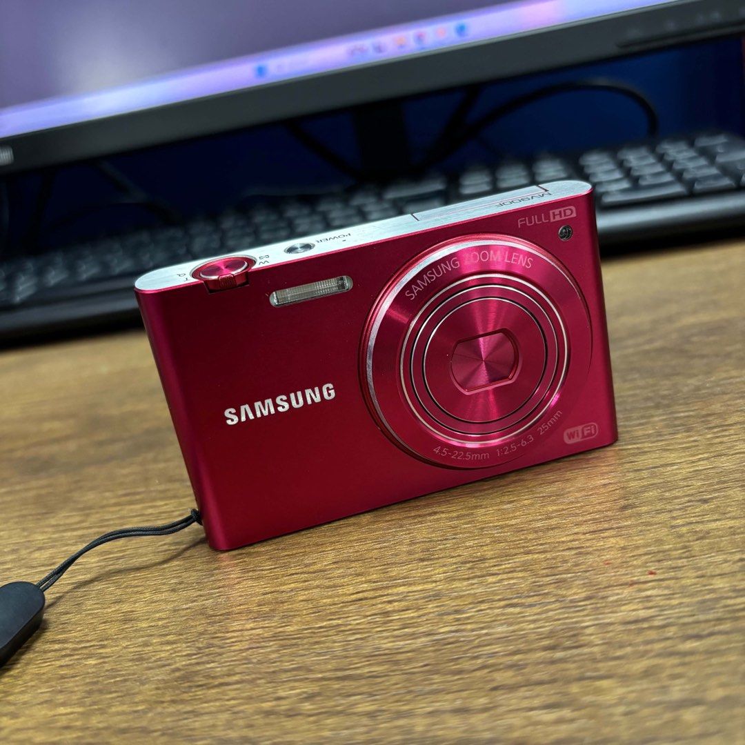 Samsung MV900F (Category: Other Gadgets) located in Manila. Submitted by xmrknthnyx (Listing ID 1464978118, Image 2). Description: Samsung MV900F (Smart Camera / MultiView) - released in 2012, famous for its 180° flip-up screen for selfies. Main Specs: Sensor: 16.3MP BSI CMOS 1/2.3" Lens: 25-125mm (equiv) f/2.5 - f/6.3, 5x Optical Zoom Stabilization: OIS (Optical) Screen: 3.3" WVGA AMOLED Touchscreen, Flips up 180° - its main selling point Video: