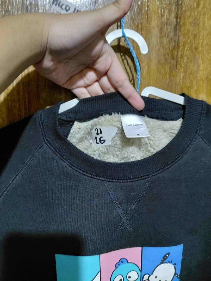 Sanrio Characters Black Fleece Sweatshirt (Category: Coats, Jackets and Outerwear) located in Imus. Submitted by frootiloots4103 (Listing ID 1464985216, Image 2). Description: - Design: Cute Sanrio graphic print featuring Pochacco, Keroppi, and Cinnamoroll - Color: Black - Size: Medium (M) - Lining: Warm and cozy white sherpa fleece interior - Style: Crew neck pullover with ribbed cuffs and hem - Condition: Great for casual, everyday wear OPEN FO