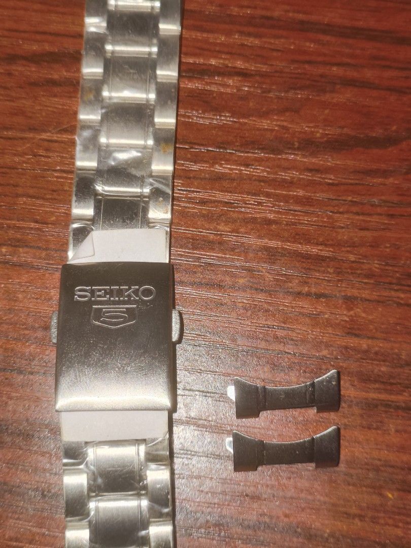 Seiko SNKL45 for sale (Category: Men's Watches) located in Manila. Submitted by bryan101 (Listing ID 1465169177, Image 3). Description: - Brand: Seiko 5 Automatic Watch no box - Dial: Black sunburst dial with a vibrant red second hand - Features: Day and date window conveniently located at 3 o'clock - Strap 1: Currently paired with a classic black leather strap - Extras: Original stainless steel bracelet with plastic wrapping.