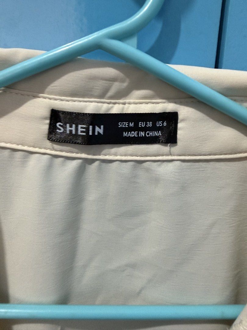SHEIN Beige Short Sleeve Button Down Blouse Size M (Category: Blouses) located in Bacoor. Submitted by celia1627 (Listing ID 1464969235, Image 2). Description: - Brand: SHEIN - Size: Medium (EU 38, US 6) - Color: Versatile beige (goes with everything!) - Style: Short rolled-up sleeves, collar neck, front button closure - Fabric: Lightweight and comfortable - Condition: Great for work, casual outings, or smart-casual looks.
