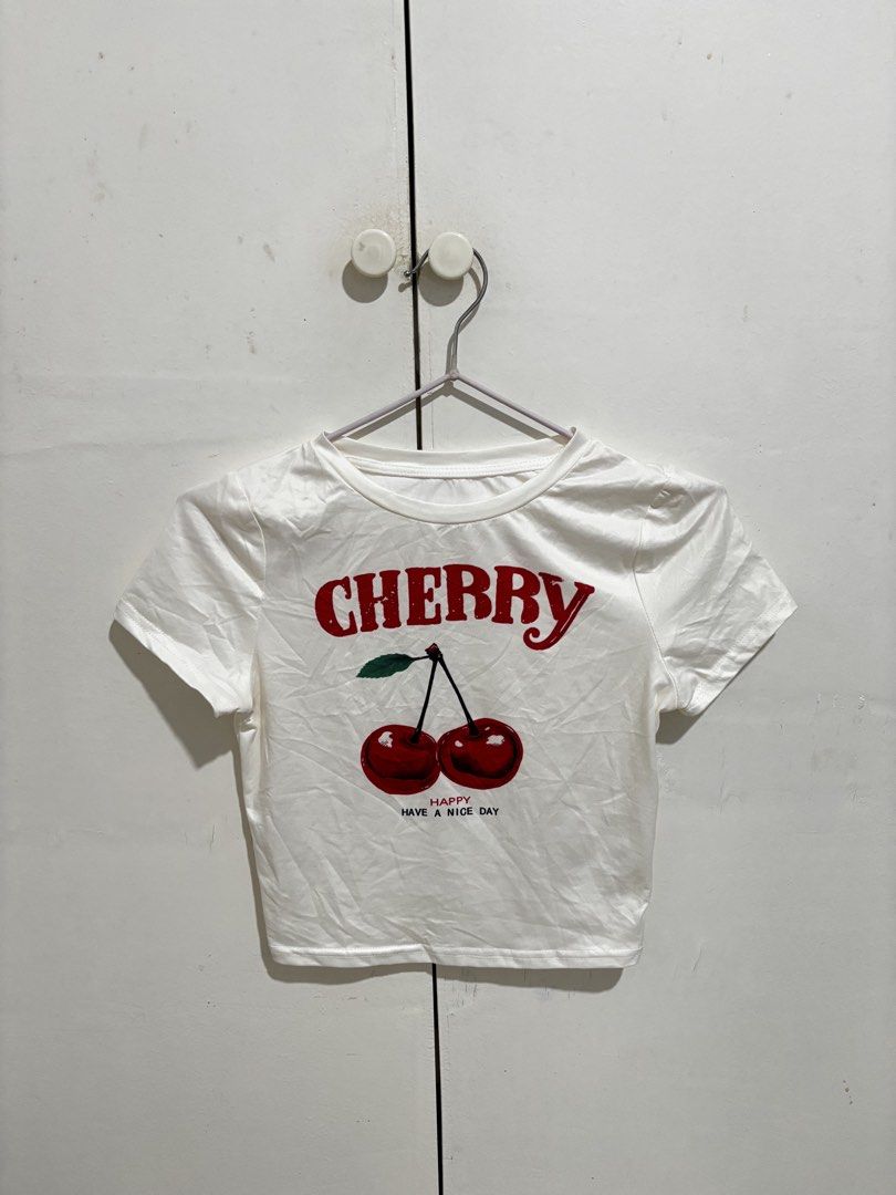 Shein White Cherry Cropped Top Shirt (Category: Shirts) located in Manila. Submitted by dianafayesimbre (Listing ID 1465071053, Image 3). Description: White cropped t-shirt with short sleeves. Red cherry graphic print on the front with 'CHERRY' and 'HAPPY HAVE A NICE DAY' lettering. Crew neckline. Size 13Y from Shein Teen but can fit xxs to small in womens. .