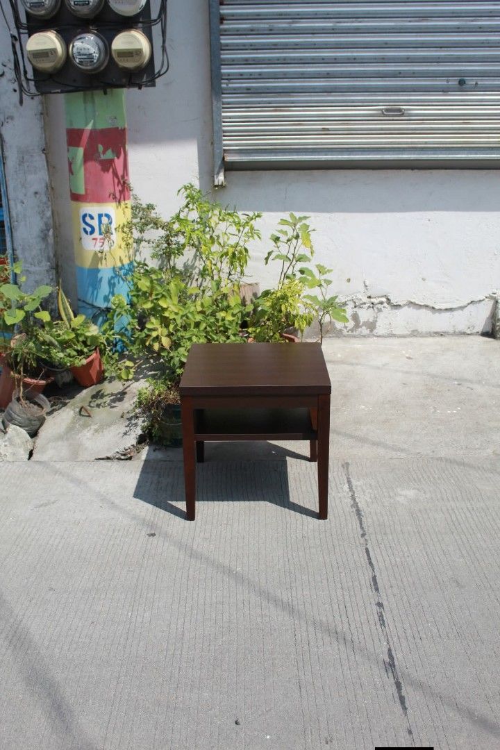 Side Table (Category: Tables & Sets) located in Meycauayan. Submitted by marygracecasimiro (Listing ID 1465164201, Image 2). Description: Dark Brown Side Table with Shelf Minimalist side table in a dark espresso brown finish with a spacious lower shelf for convenient storage. Perfect for living rooms, bedrooms or compact spaces L:19 ¾ • W: 19 ¾ • H: 19 ¾ inches 4,000 pesos only🩷🧡.
