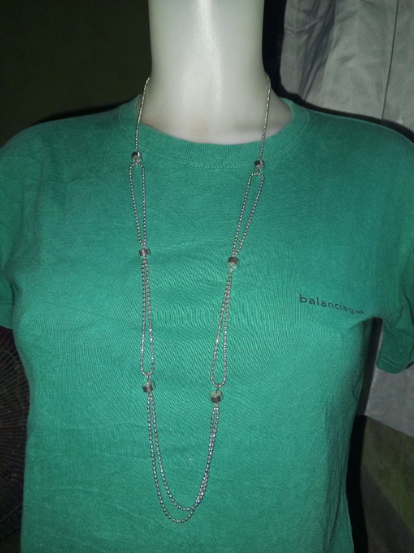 Silver Ball Chain Layered Long Necklace (Category: Necklaces) located in Magalang. Submitted by zeiansoria64090 (Listing ID 1464981452, Image 1). Description: - Silver-tone long chain necklace - Features small ball beads and cylindrical metal spacers - Creates a stylish layered drop effect - Length: Hangs past chest level - Lightweight metallic design with a simple closure ring - Perfect for pairing with casual everyday outfits and plain t-shirts