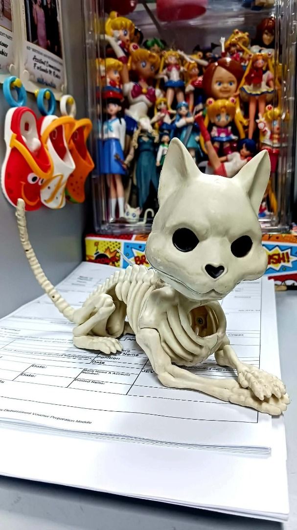SKELETON CAT ( Halloween ) (Category: Vintage Collectibles) located in Manila. Submitted by mickey_salonga (Listing ID 1465168713, Image 3). Description: - Material: White plastic - Features: Moveable joints, black eyes, cute heart-shaped nose, detailed ribs, and a long segmented tail - Design: Stands upright on paws with a hanging tag attached to the back - Perfect for: Halloween decor, spooky setups, or everyday oddities collections.