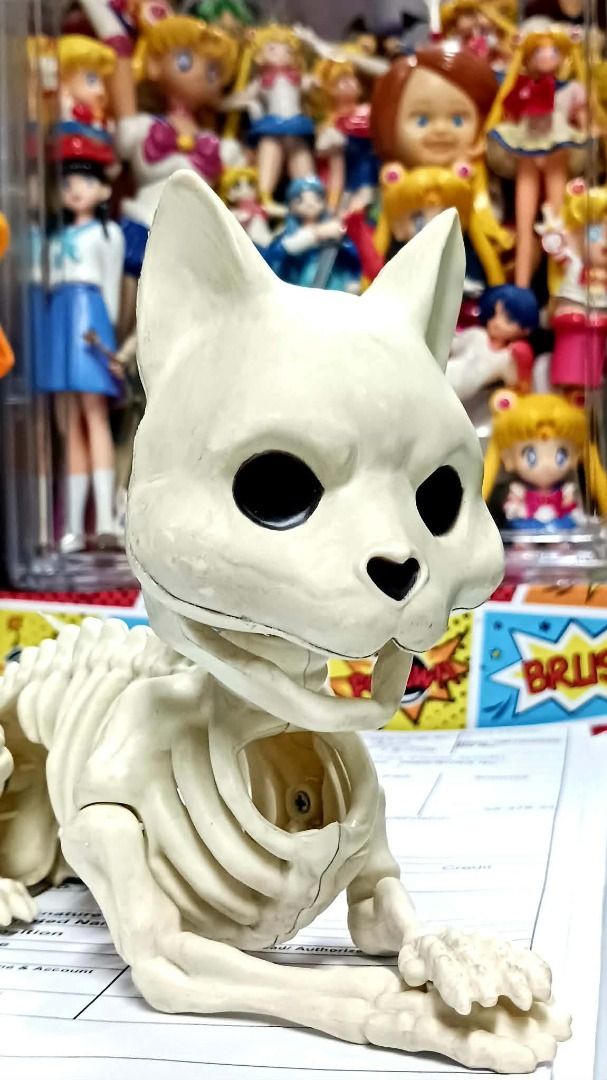 SKELETON CAT ( Halloween ) (Category: Vintage Collectibles) located in Manila. Submitted by mickey_salonga (Listing ID 1465168713, Image 1). Description: - Material: White plastic - Features: Moveable joints, black eyes, cute heart-shaped nose, detailed ribs, and a long segmented tail - Design: Stands upright on paws with a hanging tag attached to the back - Perfect for: Halloween decor, spooky setups, or everyday oddities collections.