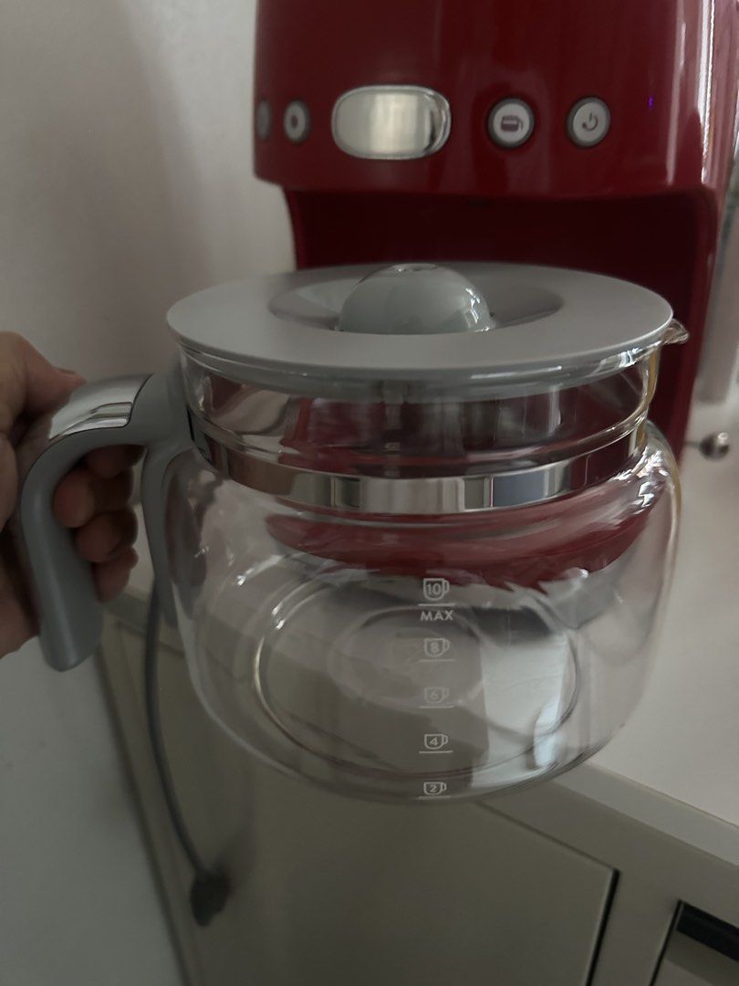 Smeg Red Drip Coffee Maker (Category: Coffee Machines & Makers) located in Manila. Submitted by majimi (Listing ID 1464985864, Image 3). Description: - Authentic Smeg Drip Coffee Machine in stunning Glossy Red Retro 50s design - Features iconic raised silver lettering and polished chrome accents - Includes 10-cup glass carafe with comfortable handle and measurement markings - Equipped with user-friendly control buttons and a clear digital display