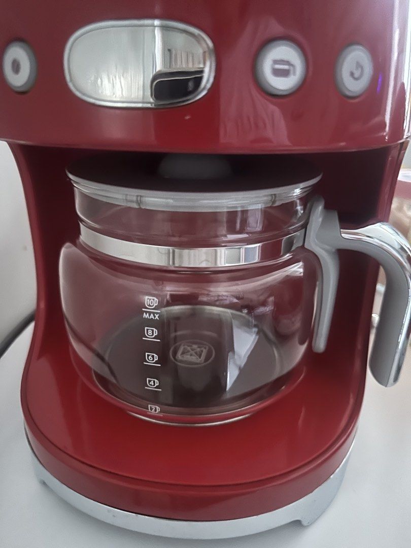 Smeg Red Drip Coffee Maker (Category: Coffee Machines & Makers) located in Manila. Submitted by majimi (Listing ID 1464985864, Image 2). Description: - Authentic Smeg Drip Coffee Machine in stunning Glossy Red Retro 50s design - Features iconic raised silver lettering and polished chrome accents - Includes 10-cup glass carafe with comfortable handle and measurement markings - Equipped with user-friendly control buttons and a clear digital display