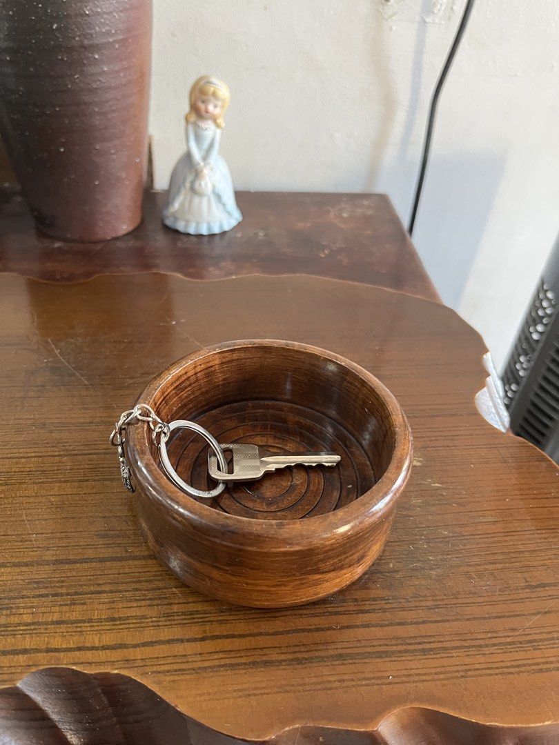 Solid wood Small Bowl Catchall Trinket Dish (Category: Vases & Decorative Bowls) located in Taguig. Submitted by minmin_parker (Listing ID 1465051963, Image 2). Description: - Material: Smooth polished wood with a rich brown finish - Design: Unique concentric circle grooves inside - Versatile Use: Great as an entryway catch-all for keys and coins, or a desk organizer for small items - Compact Size: Handy tray that fits easily on any table top - C