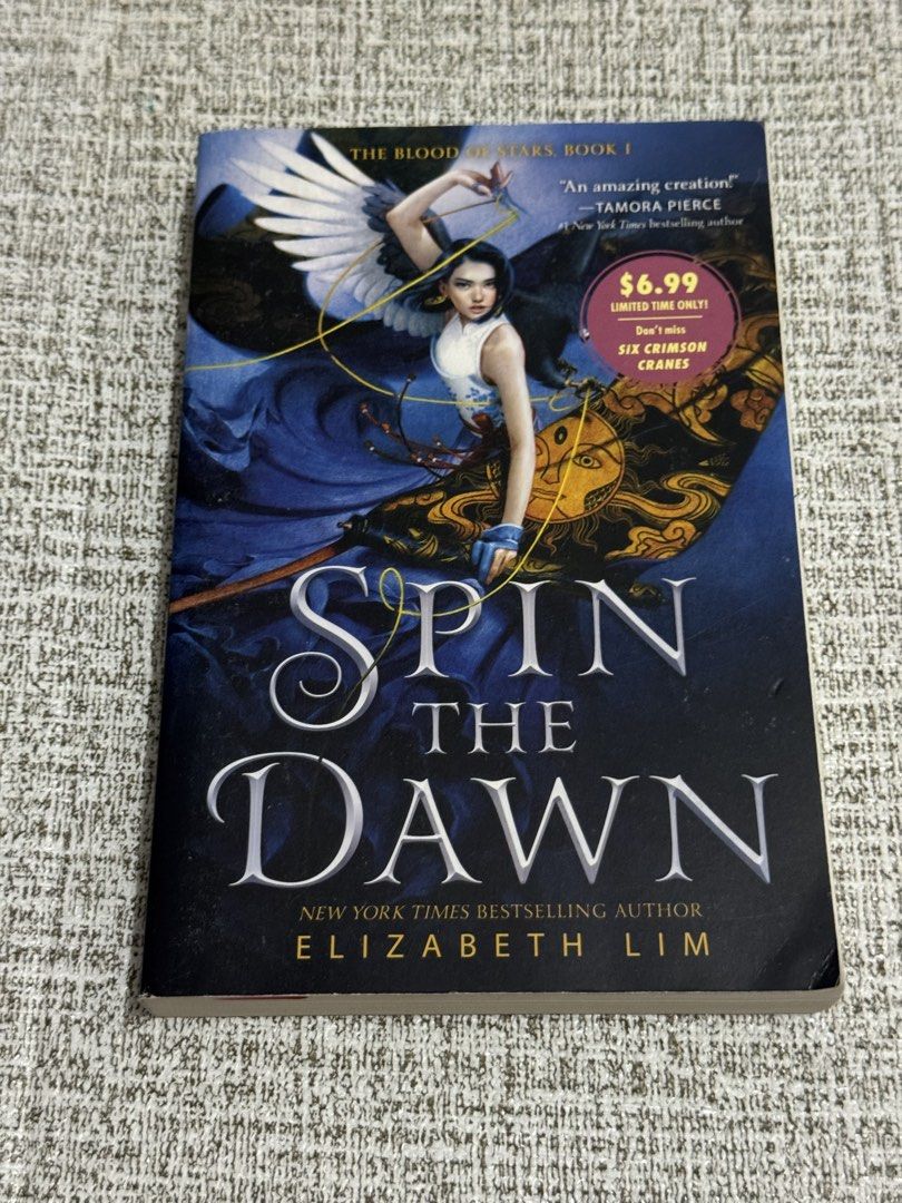 Spin the Dawn by Elizabeth Lim Paperback (Category: Storybooks) located in Cavite. Submitted by yourpahinagirly (Listing ID 1464983534, Image 1). Description: - Title: Spin the Dawn (The Blood of Stars #1) by Elizabeth Lim - Format: Paperback - Genre: Young Adult Fantasy - Synopsis: A captivating story about a young tailor competing for a royal position - Condition: Clean pages, neat spine crease from normal reading.