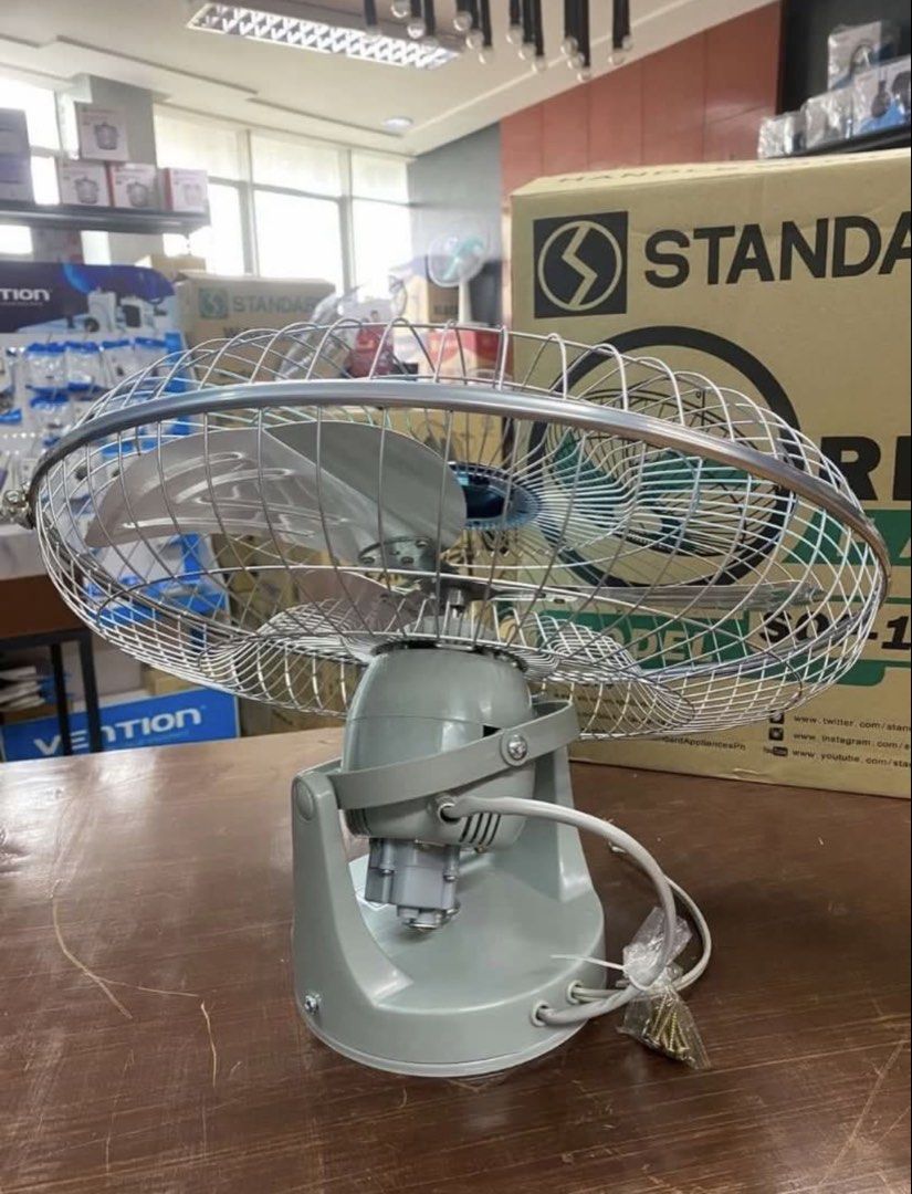 Standard Orbit Fan SOF-18T2 (Category: Fans) located in Manila. Submitted by kisshadg23 (Listing ID 1465124567, Image 2). Description: - Model: Standard Orbit Fan SOF-18T2 - Design: Blue blades with metallic protective cage and gray motor housing - Inclusions: Original box and remote control box - Condition: Unboxed, tested, and ready for setup - Perfect for efficient cooling in homes or offices.