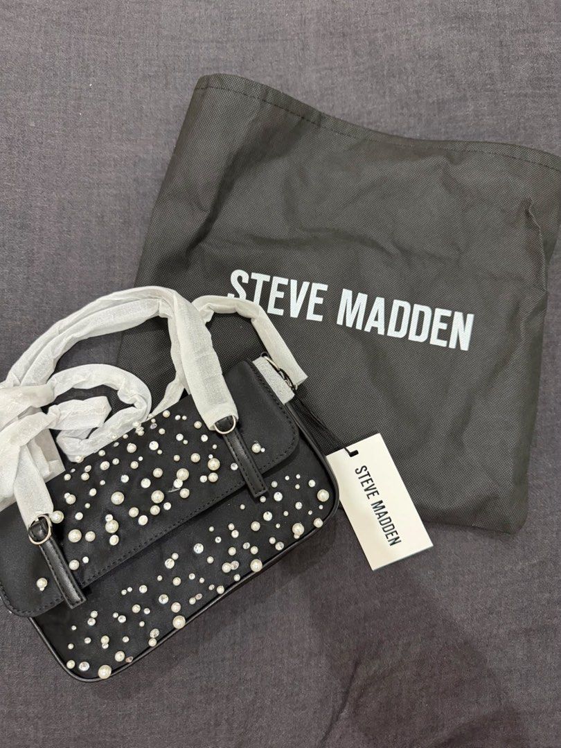 Steve Madden Embellished Shoulder Bag (Category: Luxury Bags & Wallets) located in Makati City. Submitted by konomi.phh (Listing ID 1465082947, Image 1). Description: - Brand: Steve Madden - Style: Black shoulder bag with faux pearls and rhinestones - Hardware: Silver-tone turn-lock closure - Interior: Clean black fabric lining with brand logo - Condition: Brand new, never used, immaculate inside and out - Extras: Includes original dust bag and h