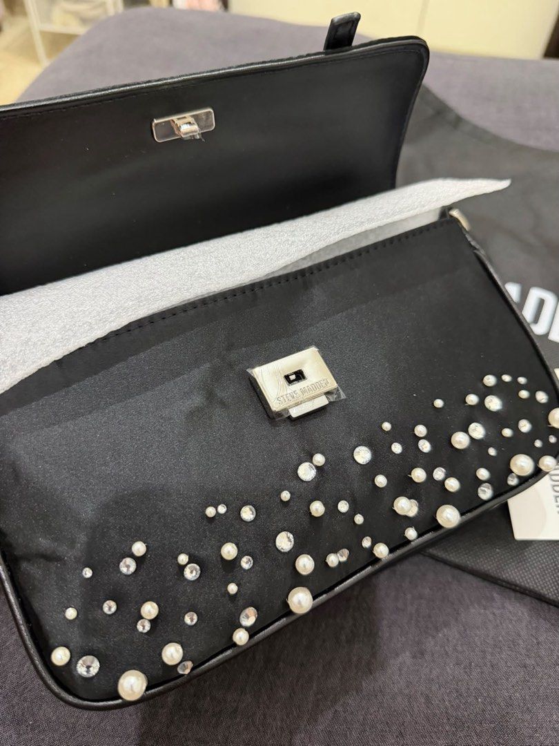 Steve Madden Embellished Shoulder Bag (Category: Luxury Bags & Wallets) located in Makati City. Submitted by konomi.phh (Listing ID 1465082947, Image 2). Description: - Brand: Steve Madden - Style: Black shoulder bag with faux pearls and rhinestones - Hardware: Silver-tone turn-lock closure - Interior: Clean black fabric lining with brand logo - Condition: Brand new, never used, immaculate inside and out - Extras: Includes original dust bag and h