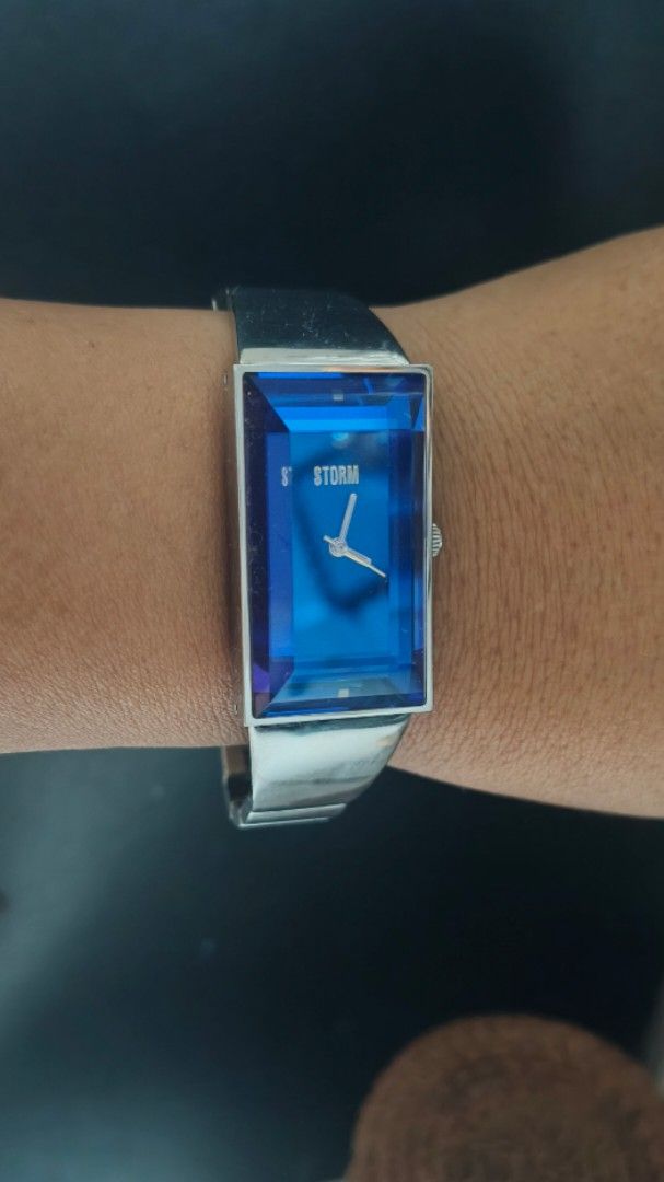 Storm Porto Rare elegant Blue Crystal Rectangular Watch (Category: Women's Watches) located in Taguig. Submitted by mercyeugen28914 (Listing ID 1465104308, Image 1). Description: - Brand: Storm London - Design: Rectangular silver-tone case with a unique blue faceted crystal glass - Strap: Matching metal bracelet strap - Dial: Classic analog dial with silver hands - Condition: Minimal wear on casing - Versatility: Perfect statement accessory for d