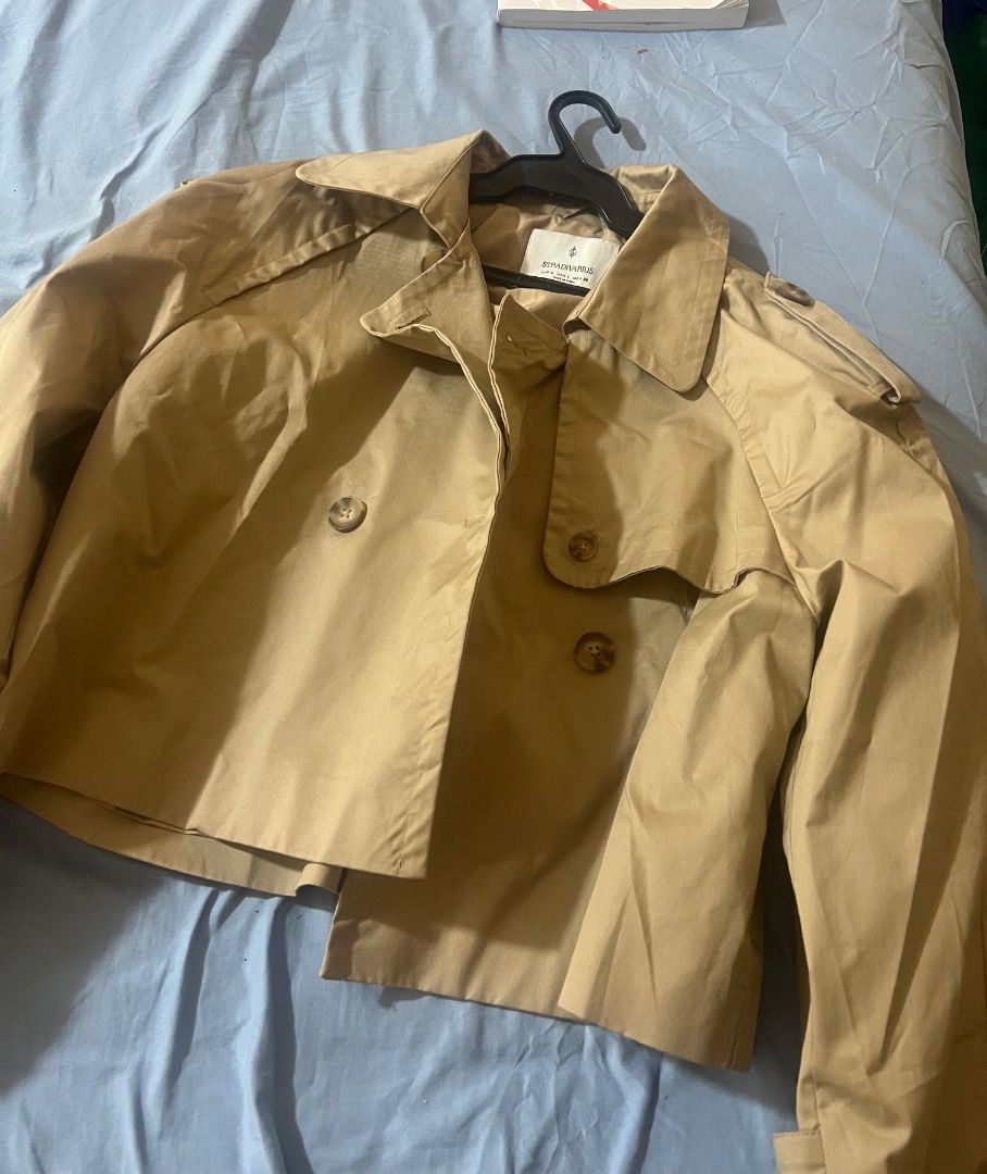 Stradivarius Beige Cropped Trench Jacket Size L (Category: Coats, Jackets and Outerwear) located in Pasay City. Submitted by sharshay317 (Listing ID 1465167695, Image 1). Description: Stradivarius cropped trench jacket in beige. Double-breasted front with tortoiseshell buttons, lapel collar, and shoulder epaulets. Size L EUR and USA. Clean styling, easy to layer over tops and dresses. Bought this but didn’t get to wear it so basically it is still