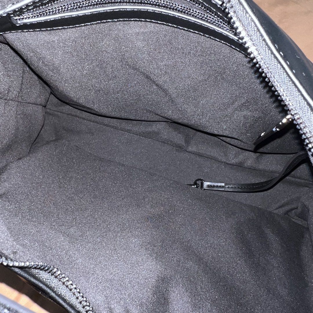 Straightforward Black Leather Shoulder Bag with Extra Strap (Category: Shoulder Bags) located in Lubao. Submitted by ad_apparel (Listing ID 1465017640, Image 3). Description: - Brand: Straightforward - Color: Black - Material: Smooth synthetic leather - Features: Multiple exterior pockets and zippers, debossed logo on the front and strap, dark fabric-lined main compartment - Inclusion: Extra detachable strap in original plastic packaging - Condit
