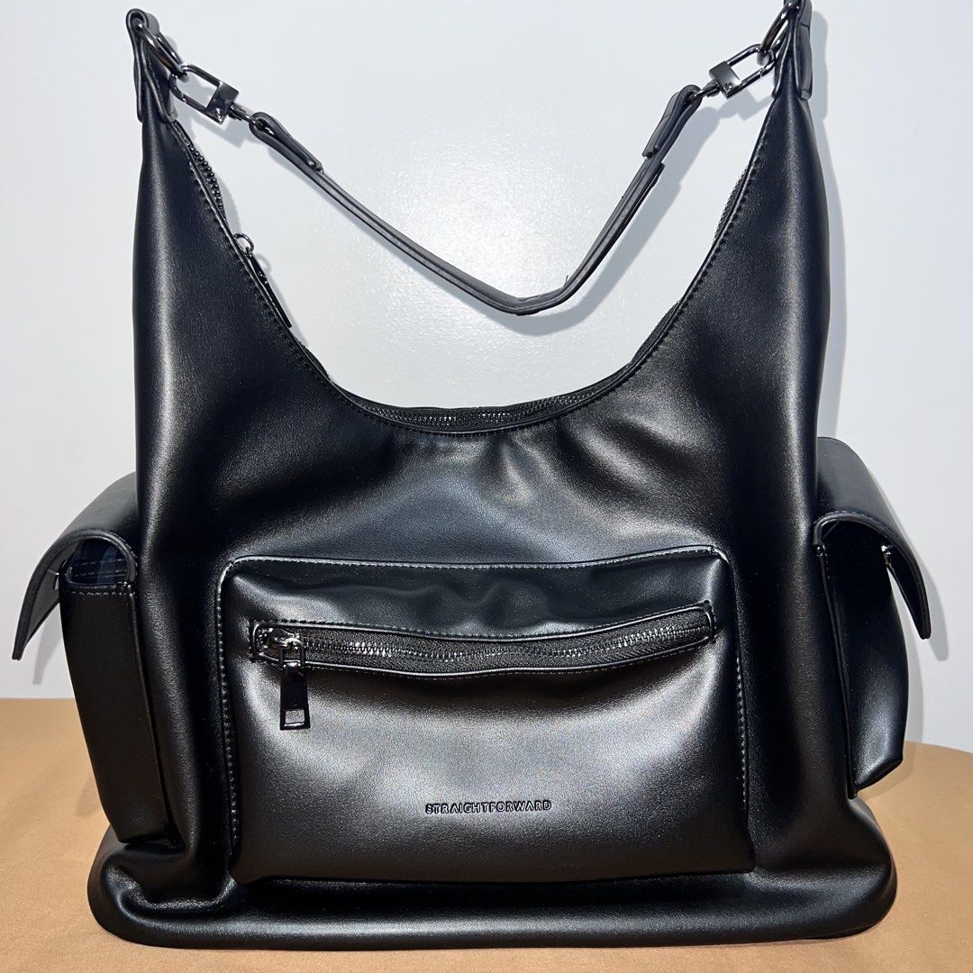 Straightforward Black Leather Shoulder Bag with Extra Strap (Category: Shoulder Bags) located in Lubao. Submitted by ad_apparel (Listing ID 1465017640, Image 1). Description: - Brand: Straightforward - Color: Black - Material: Smooth synthetic leather - Features: Multiple exterior pockets and zippers, debossed logo on the front and strap, dark fabric-lined main compartment - Inclusion: Extra detachable strap in original plastic packaging - Condit