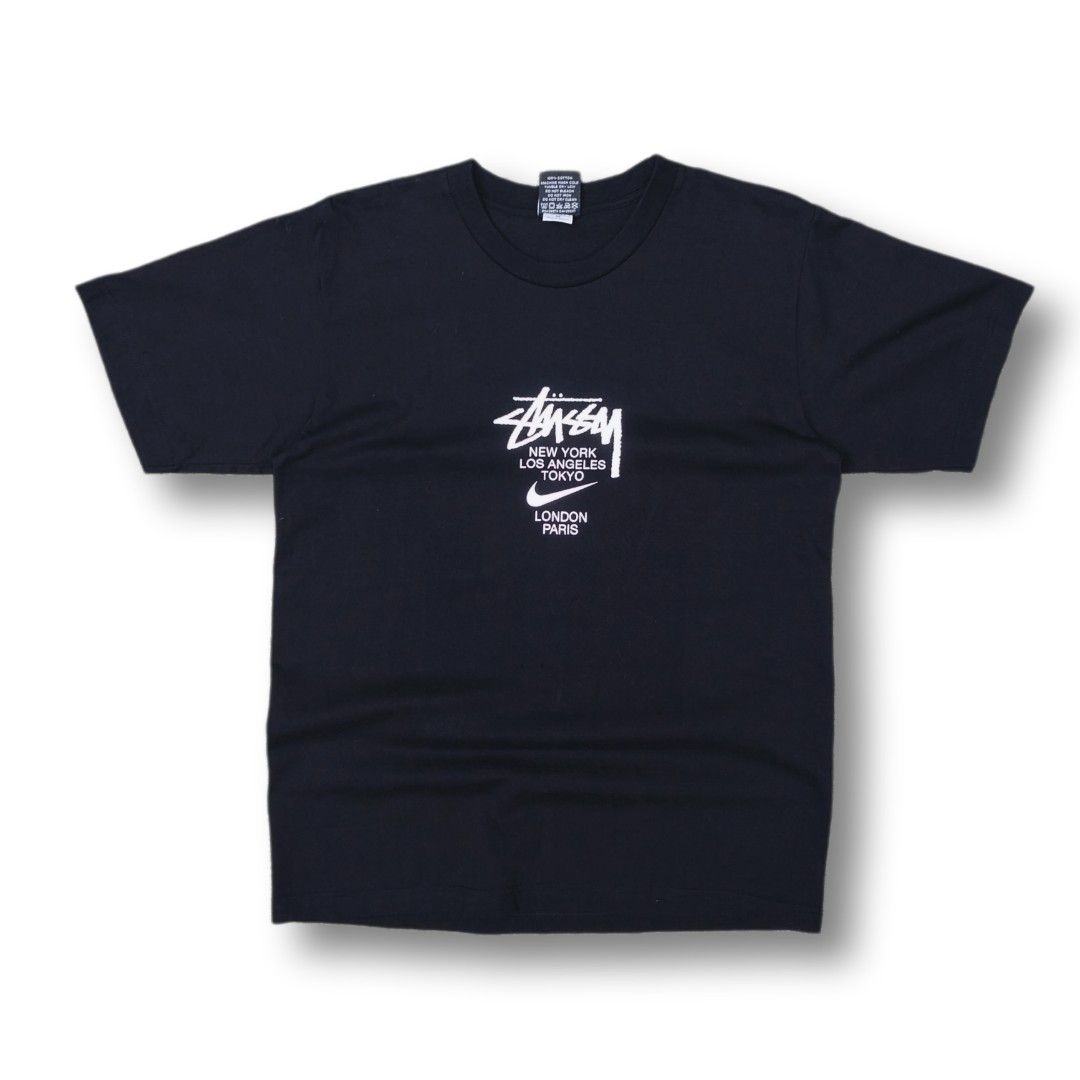 Stussy x Nike (OFF/LEGIT) (Category: Tshirts & Polo Shirts ) located in Cavite. Submitted by spinfits (Listing ID 1465109887, Image 2). Description: - Brand: Stussy x Nike - Color: Black - Material: 100% Premium Cotton - Design: Classic graffiti World Tour cities logo on front, large custom sneaker graphic with Stussy script on back - Fit: Standard crew neck, short sleeves Size: S-M (Width: 20") (Length: 28") INCHES Condition: (Lighly used) Color