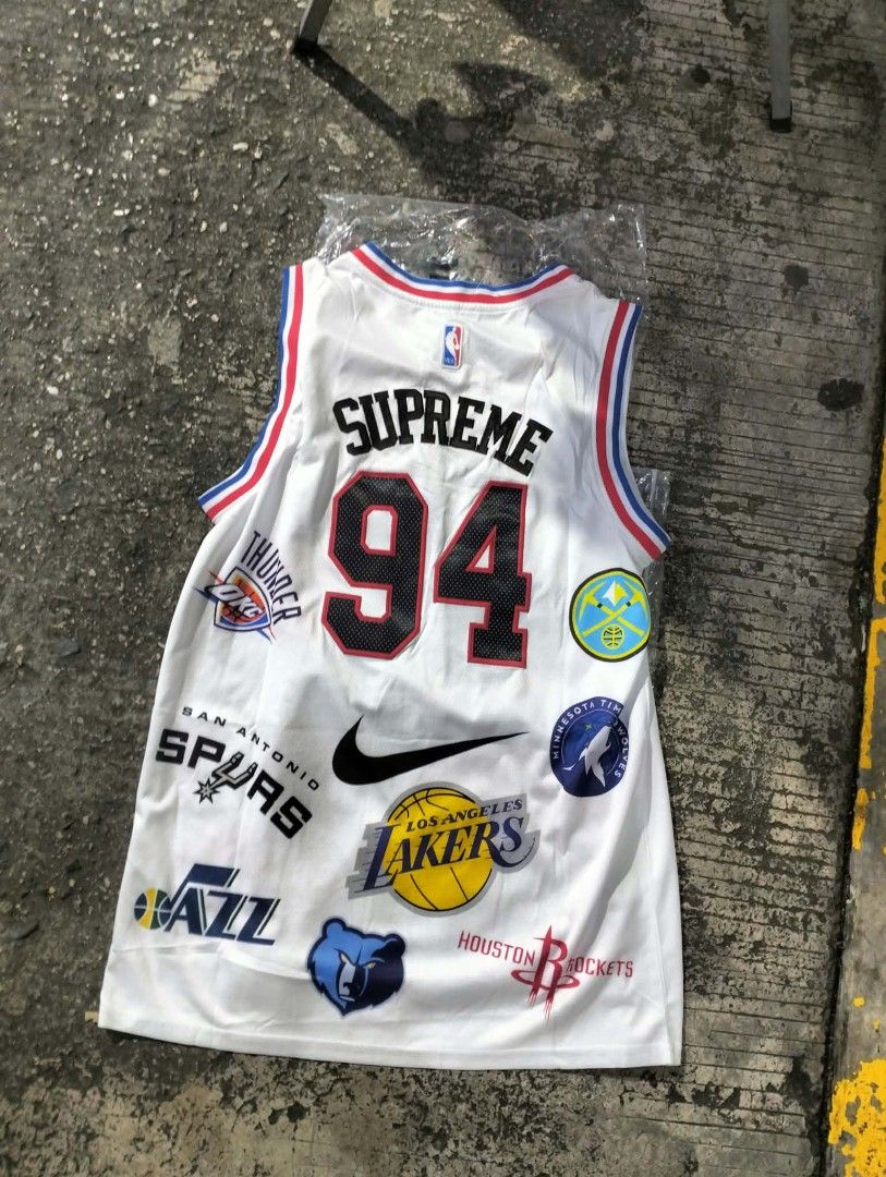Supreme NBA Teams White Jersey 94 (Category: Activewear) located in Manila. Submitted by young_thrift001 (Listing ID 1465076299, Image 1). Description: - Brand new, still sealed in original plastic packaging - Supreme x Nike collaboration basketball jersey in white - Size 52 (tag at bottom hem) - Eye-catching all-over multi-NBA team logos on front and back - Large Supreme branding and number 94 on the back - Nike swoosh embroidery near the collar