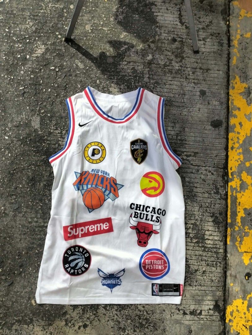 Supreme NBA Teams White Jersey 94 (Category: Activewear) located in Manila. Submitted by young_thrift001 (Listing ID 1465076299, Image 2). Description: - Brand new, still sealed in original plastic packaging - Supreme x Nike collaboration basketball jersey in white - Size 52 (tag at bottom hem) - Eye-catching all-over multi-NBA team logos on front and back - Large Supreme branding and number 94 on the back - Nike swoosh embroidery near the collar